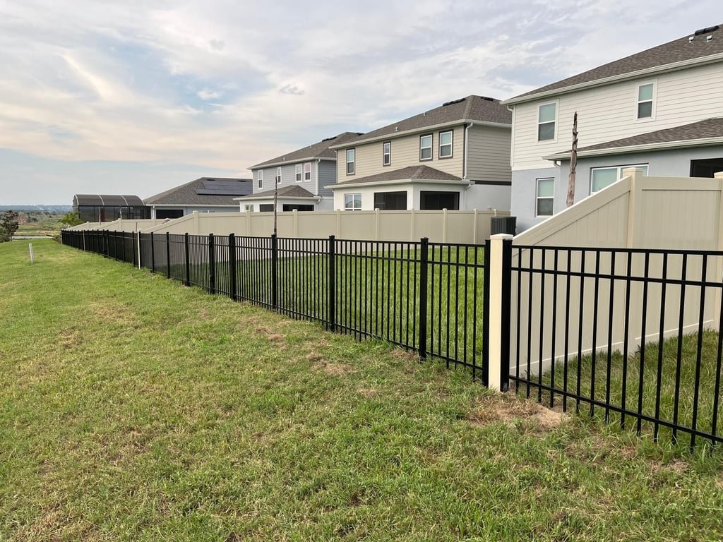 Black aluminum fence with vinyl privacy fence installed by O-Town Fencing