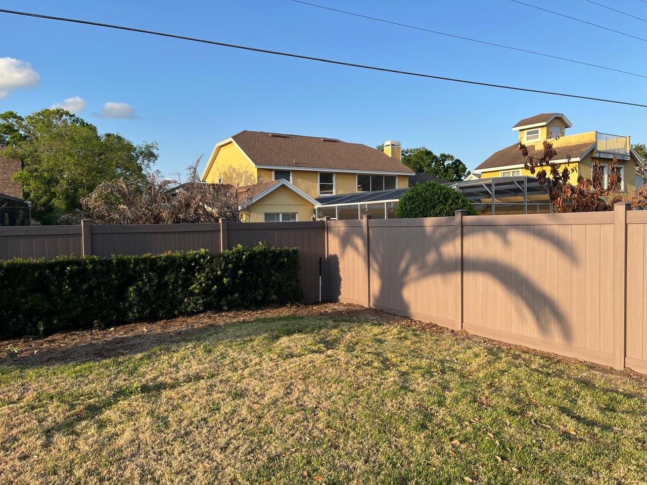Tan vinyl privacy fence installed in Central Florida